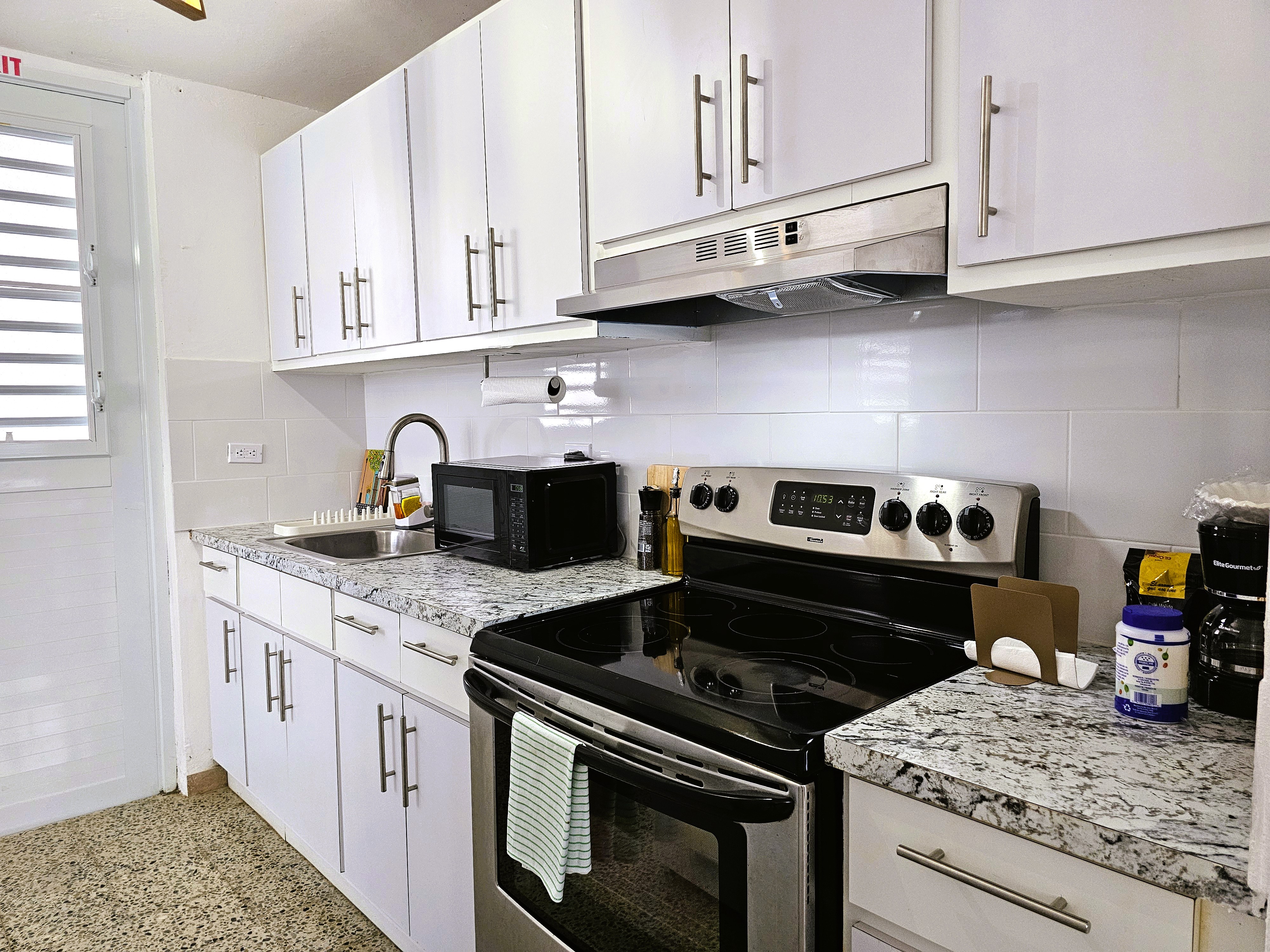 Bright modern kitchen with stainless appliances and ample storage
