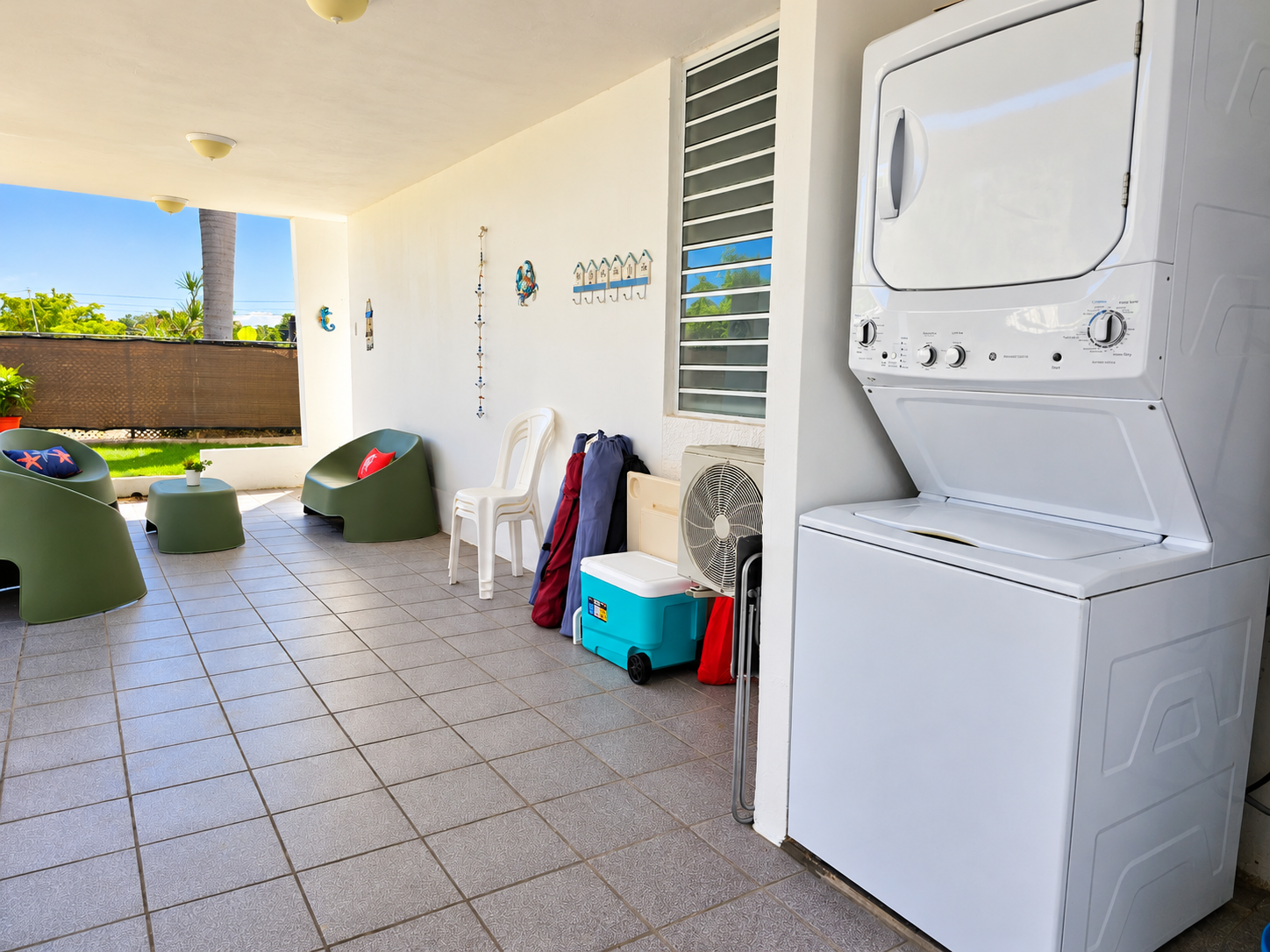Covered patio with lounge seating and convenient in-unit washer/dryer