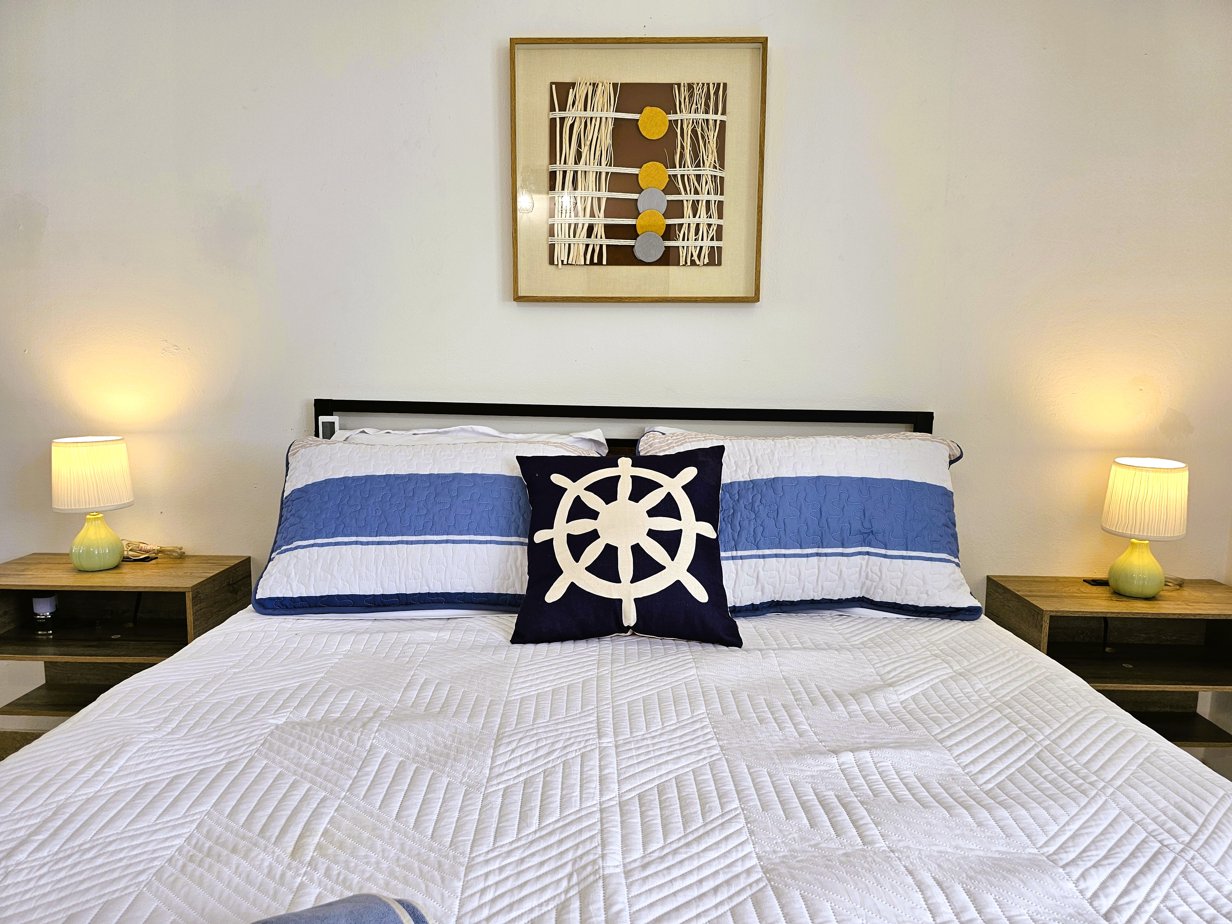 Cozy nautical-style bedroom with warm bedside lighting