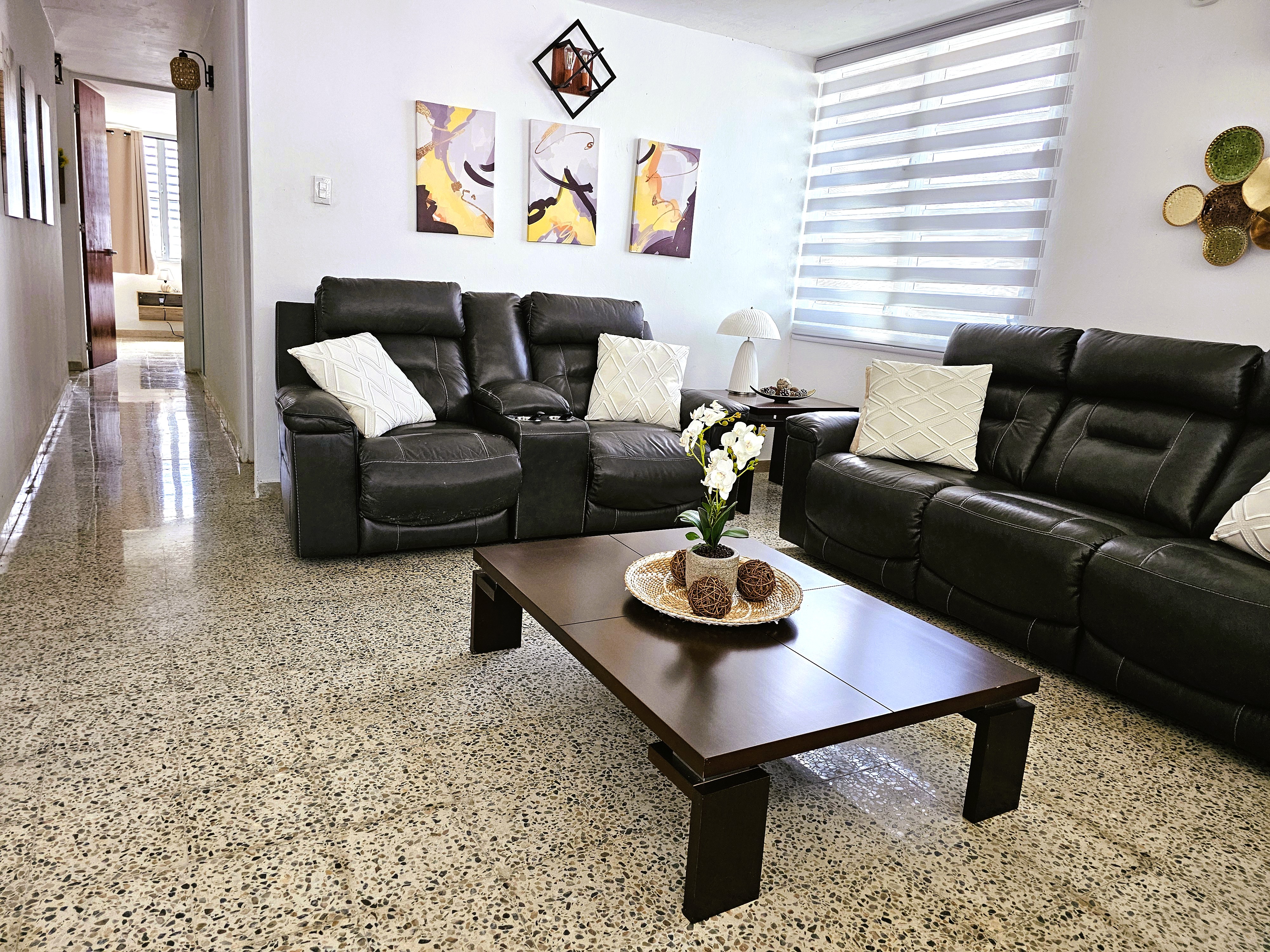 Bright modern living room with leather sofas and plenty of natural light