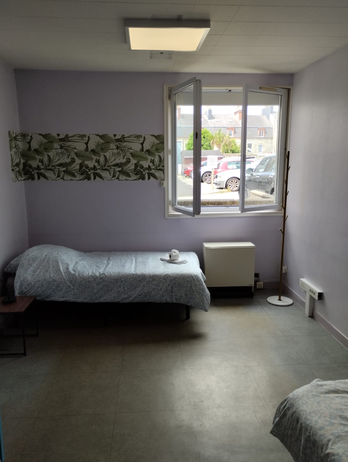 Bright twin room with natural light and clean, simple layout