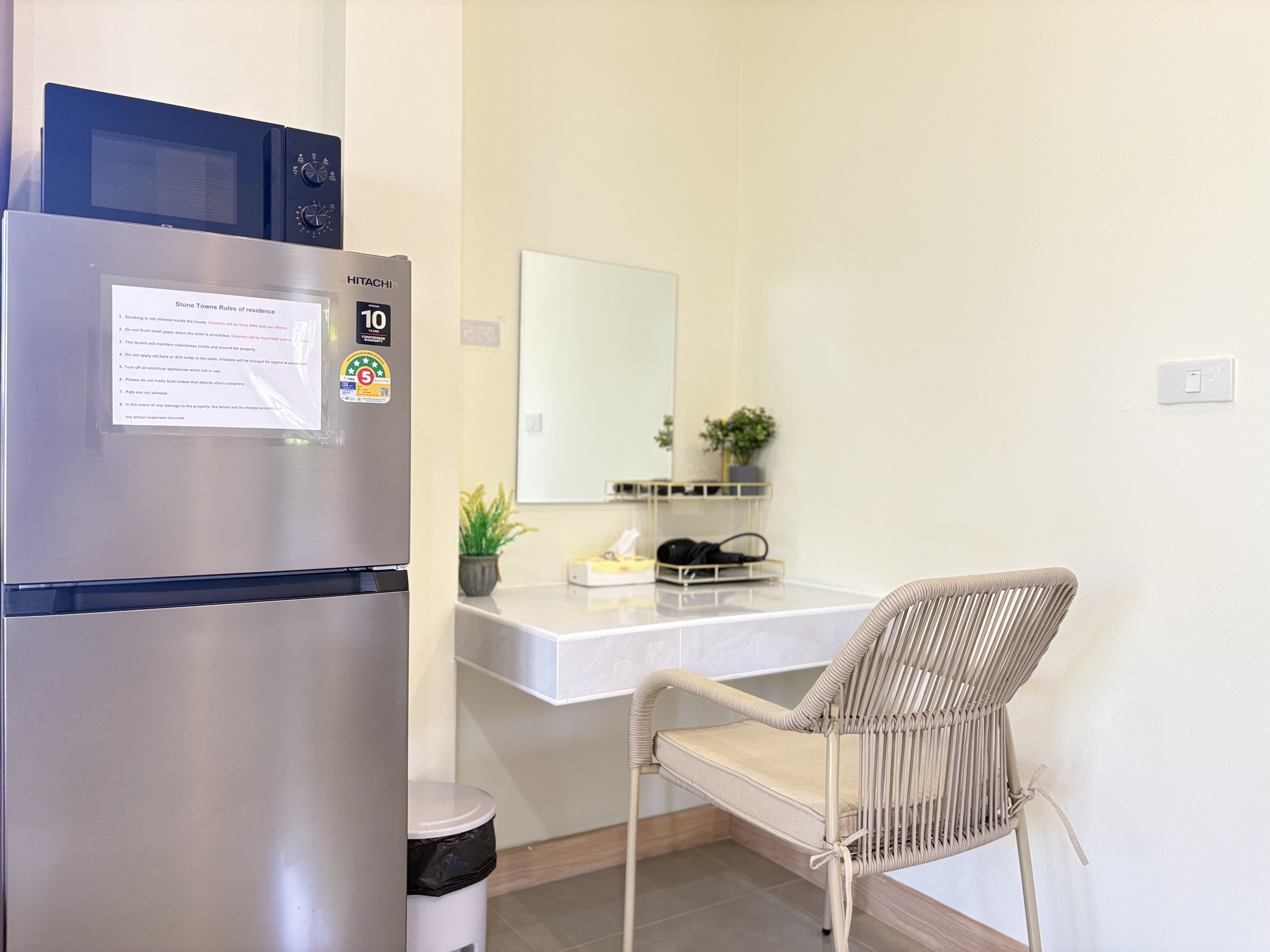 Convenient vanity corner with fridge, microwave, and stylish seating
