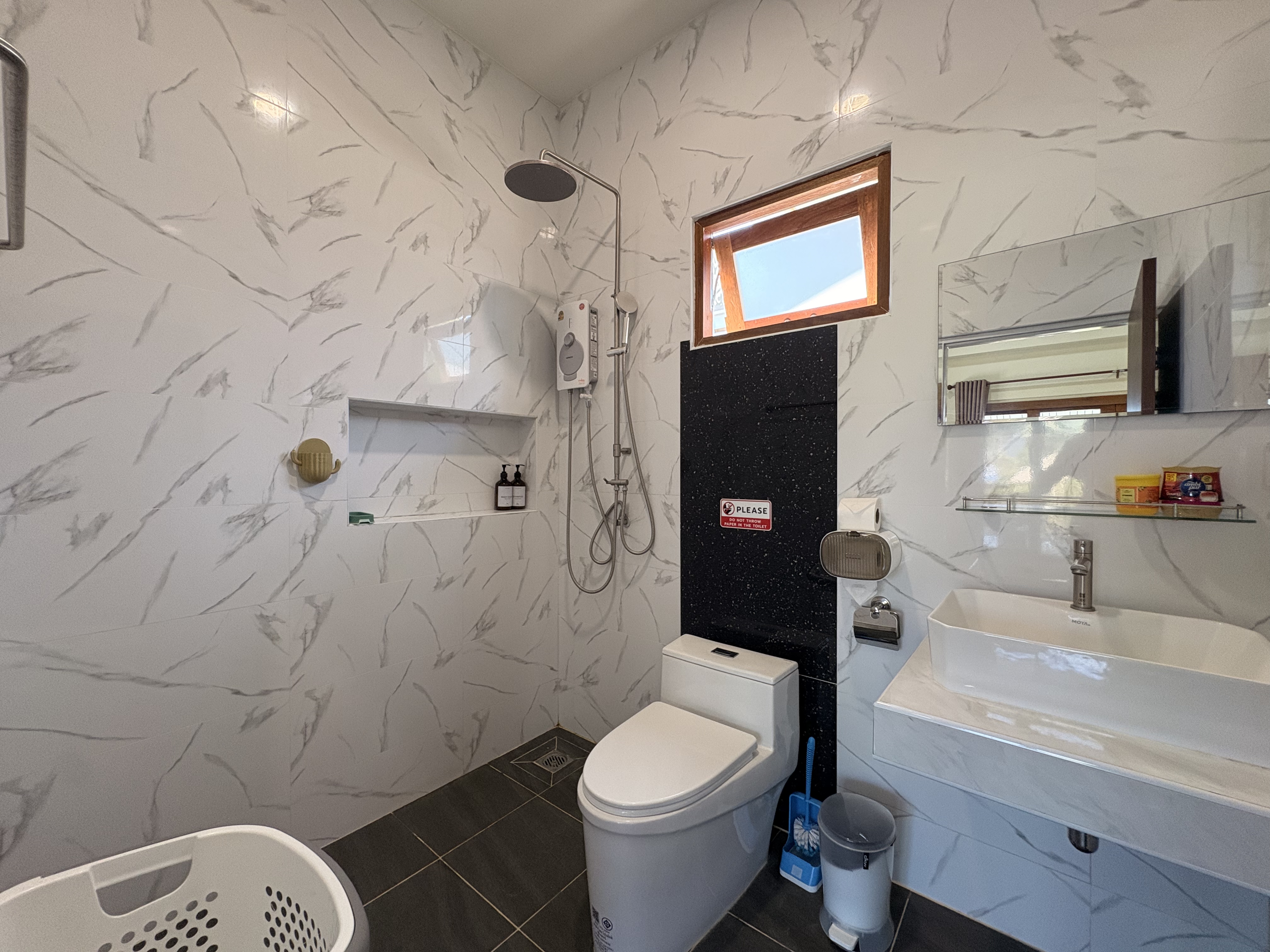 Bright modern bathroom with rainfall shower and elegant marble-style finishes