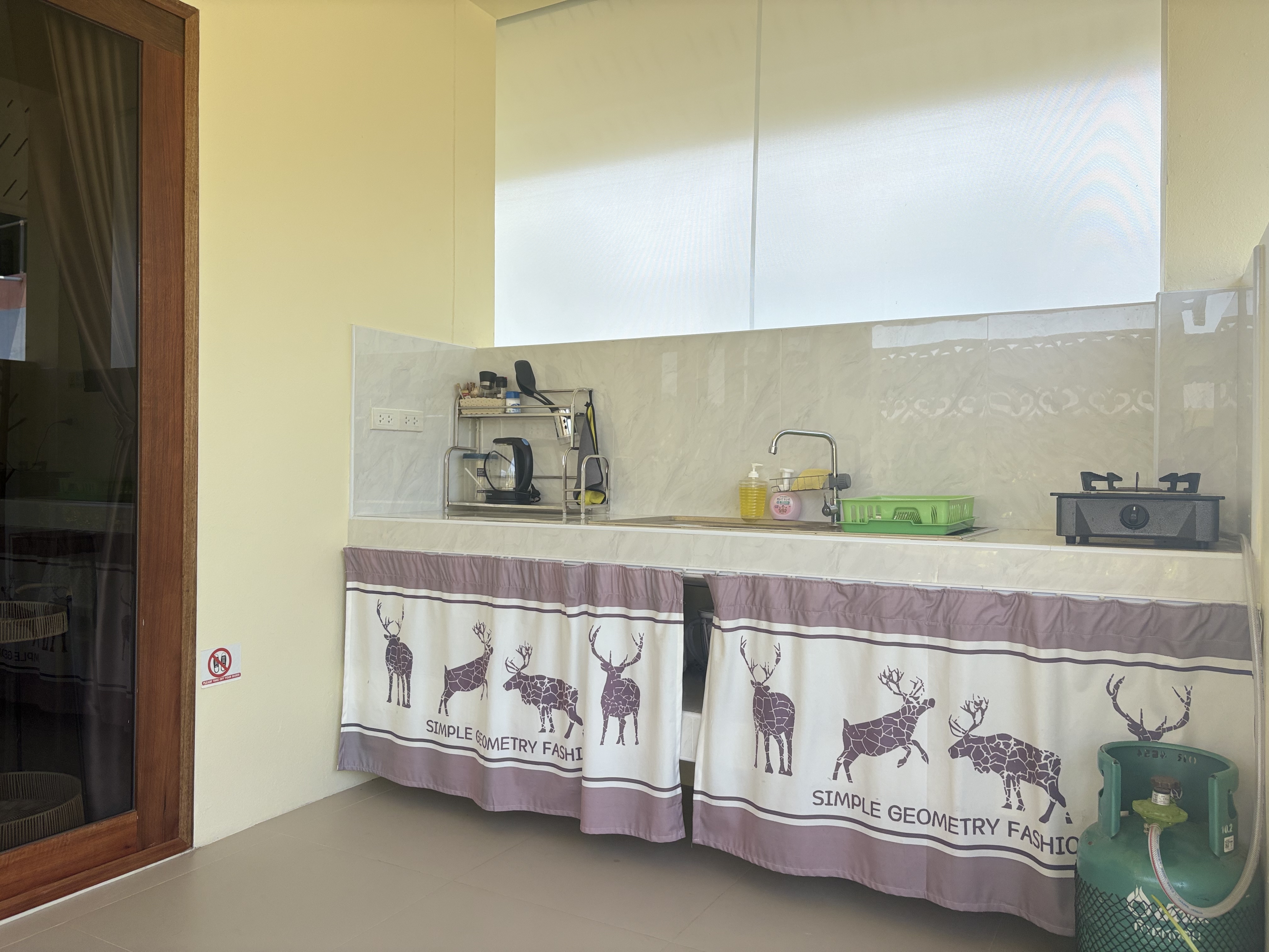 Bright, practical kitchenette with sink, burner, and handy prep space