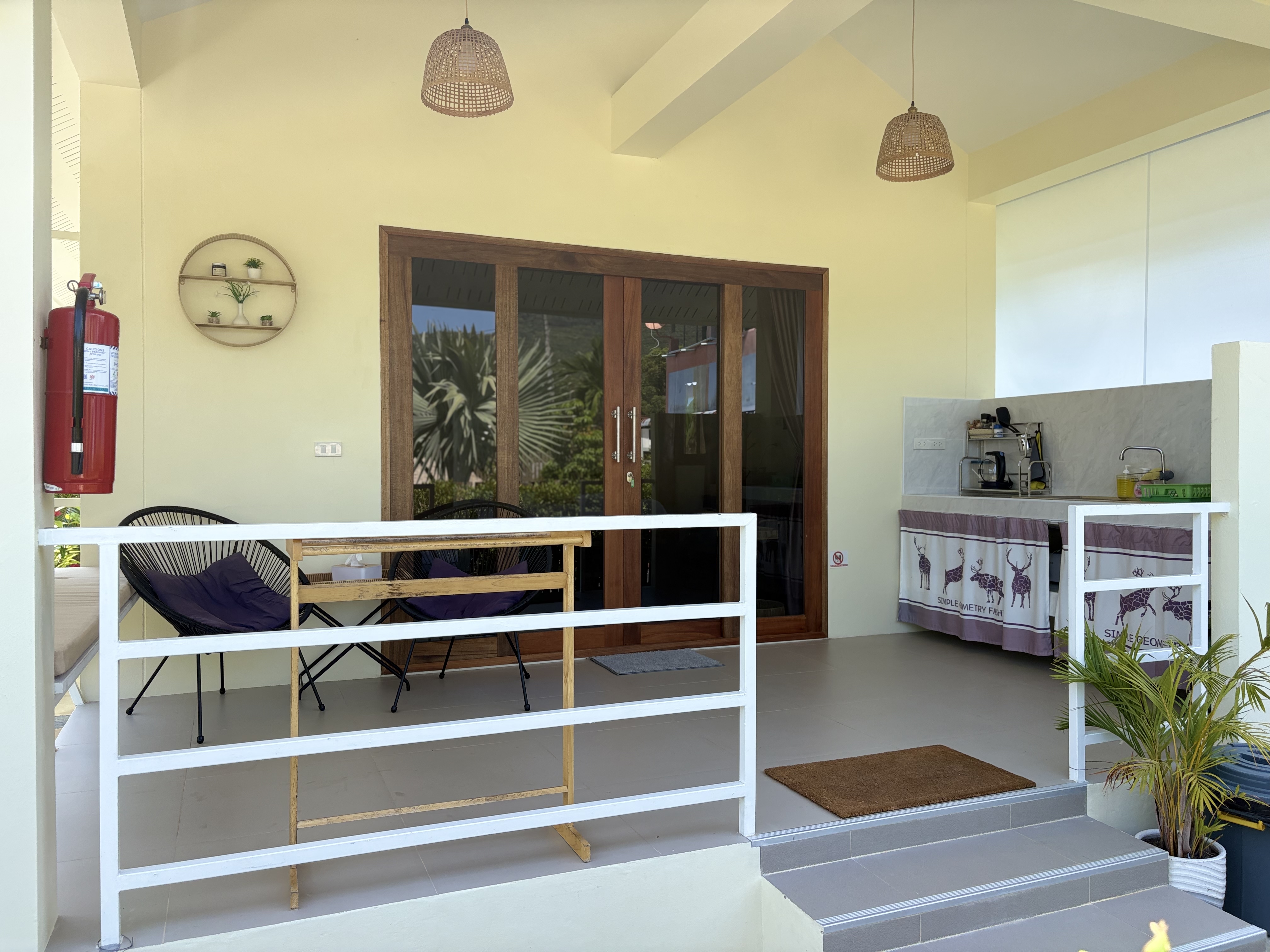 Bright covered patio with seating, glass doors, and handy coffee station