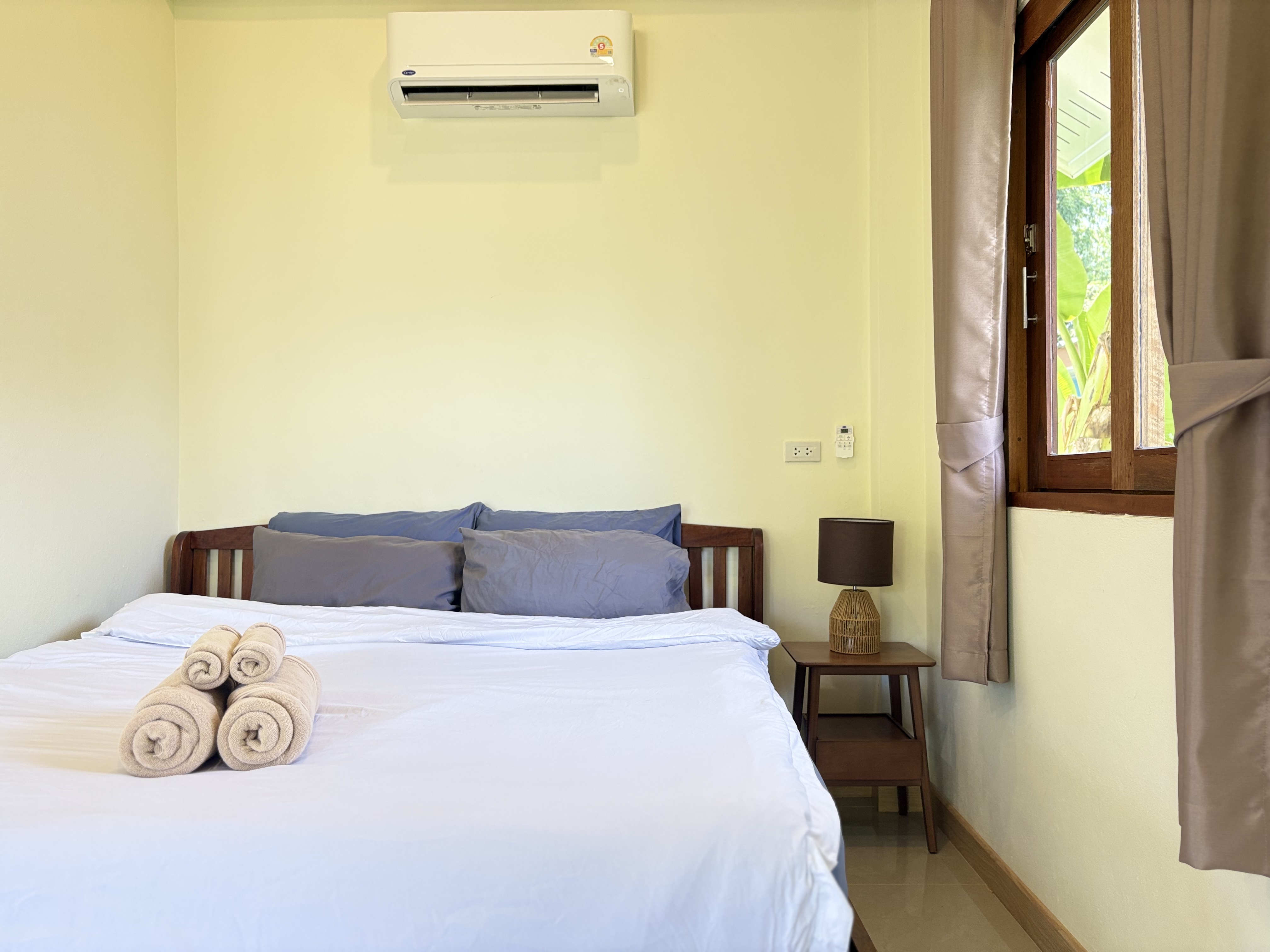 Bright, air-conditioned bedroom with crisp linens and natural light