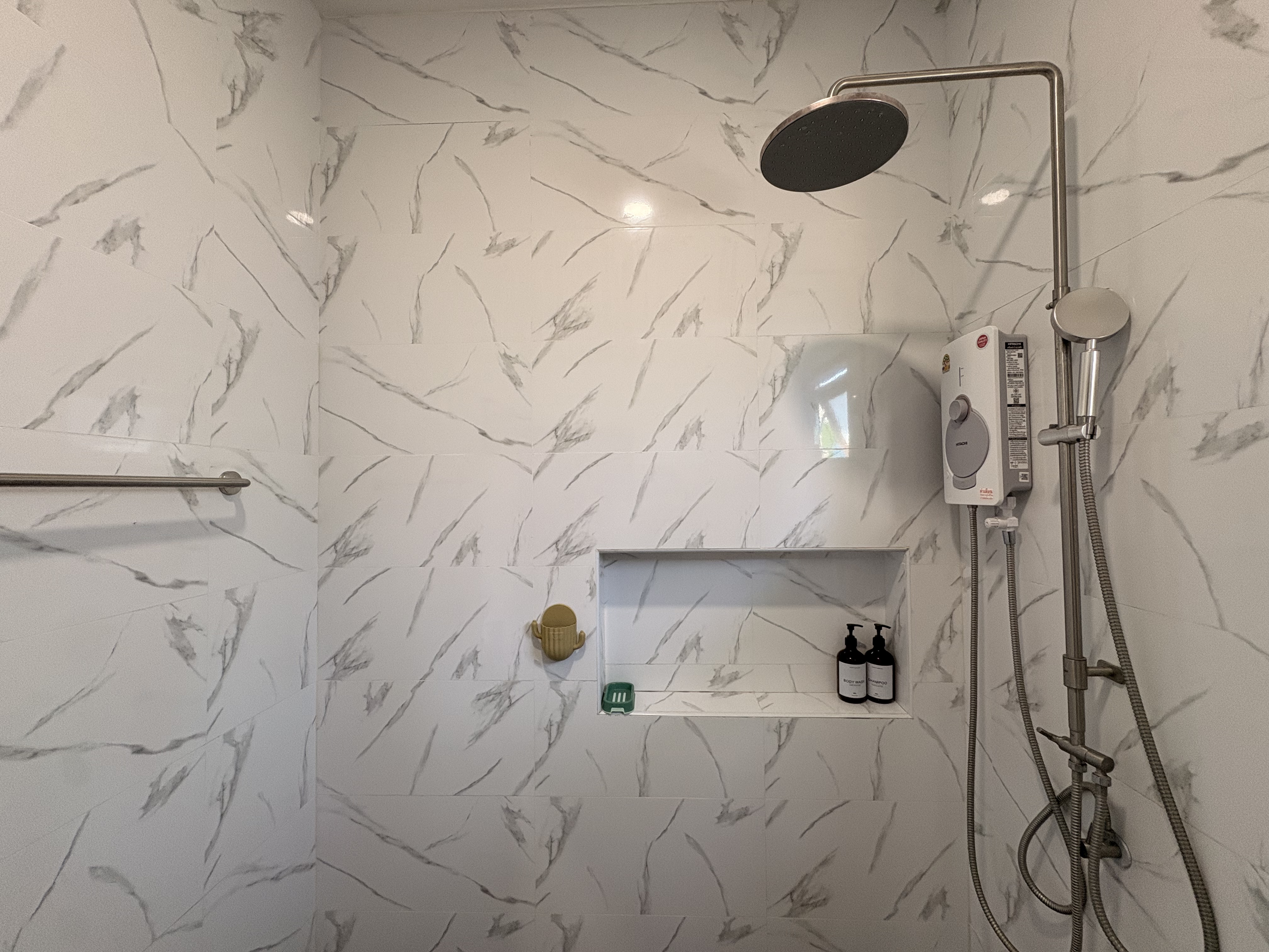 Spa-style walk-in shower with rainfall head and elegant marble-look tile