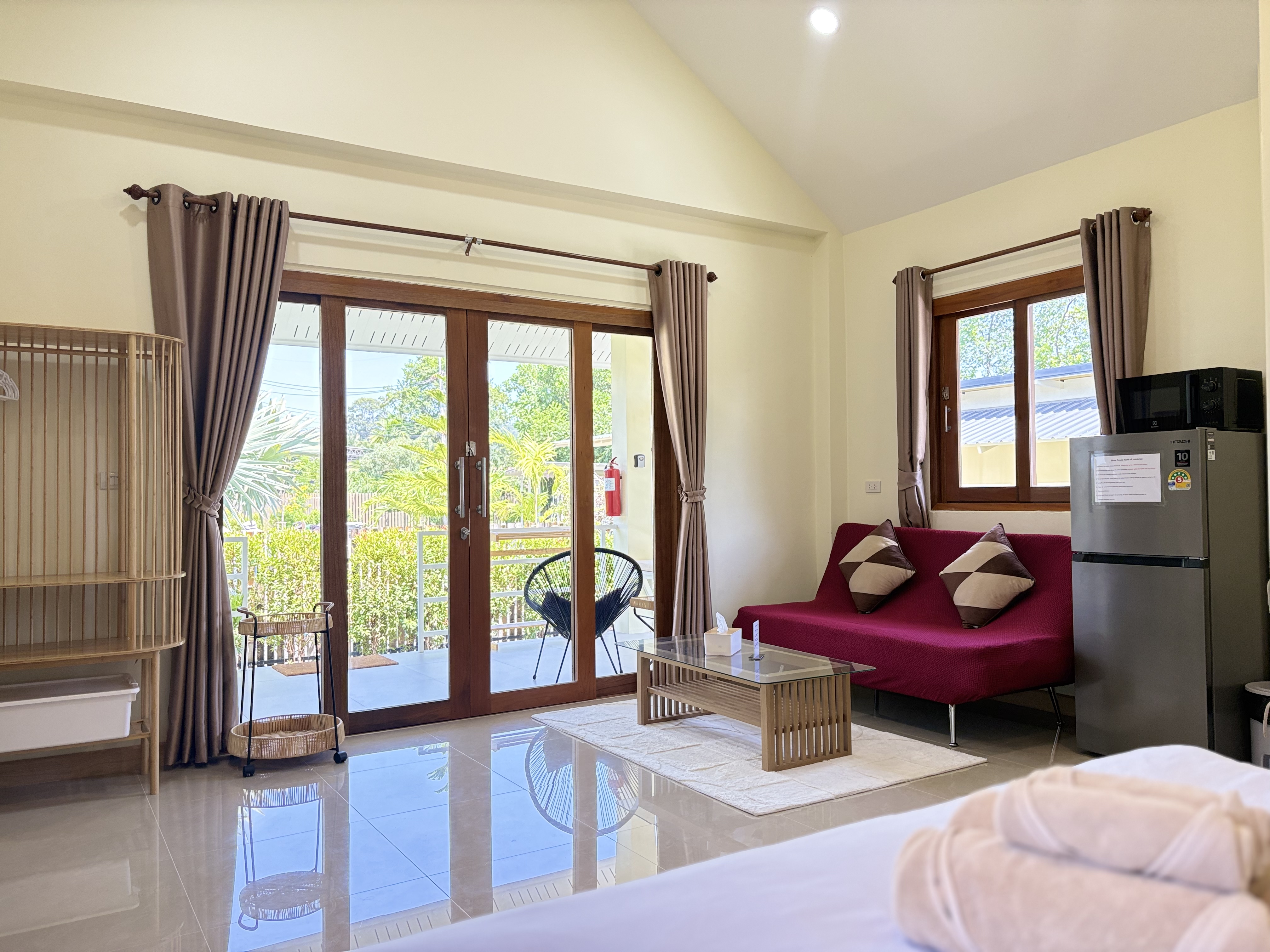 Bright garden-view studio with private patio and cozy lounge area