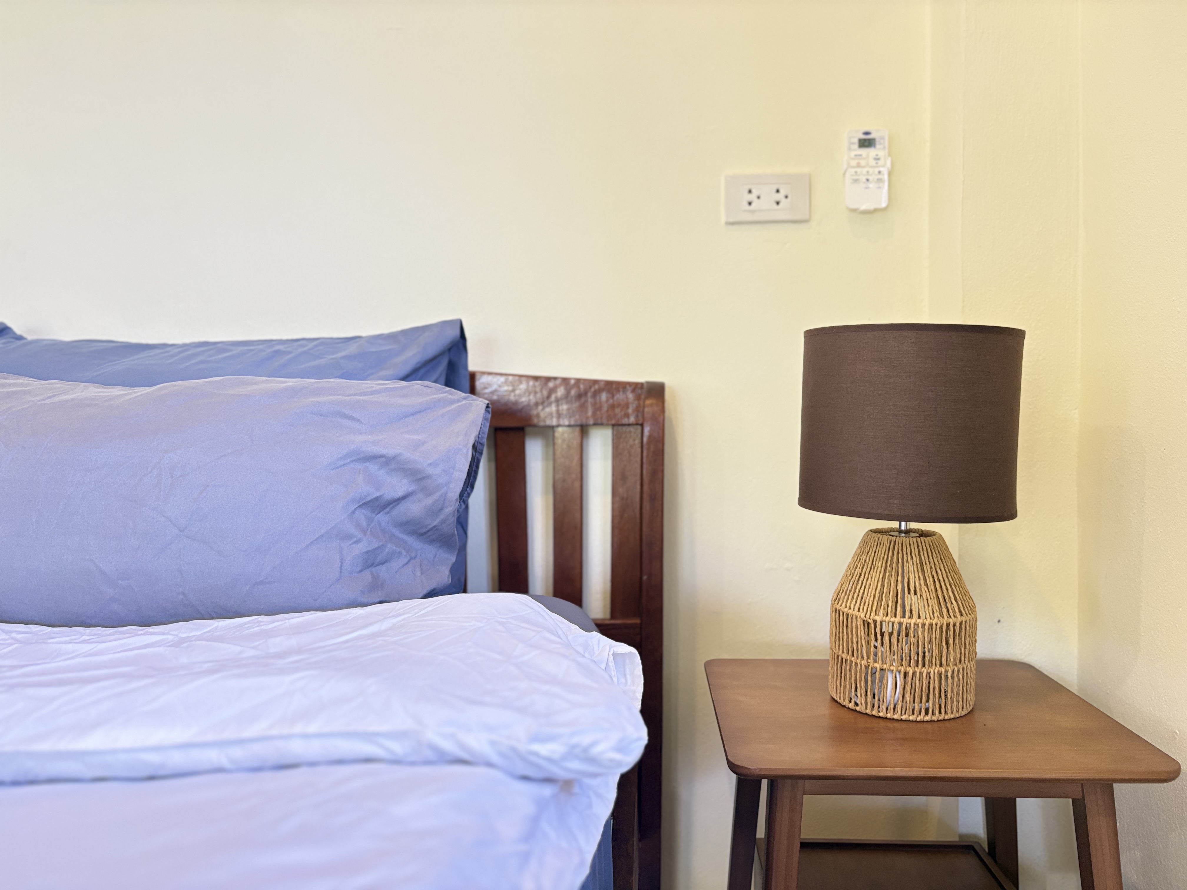 Cozy bedside setup with soft linens and warm, minimalist style