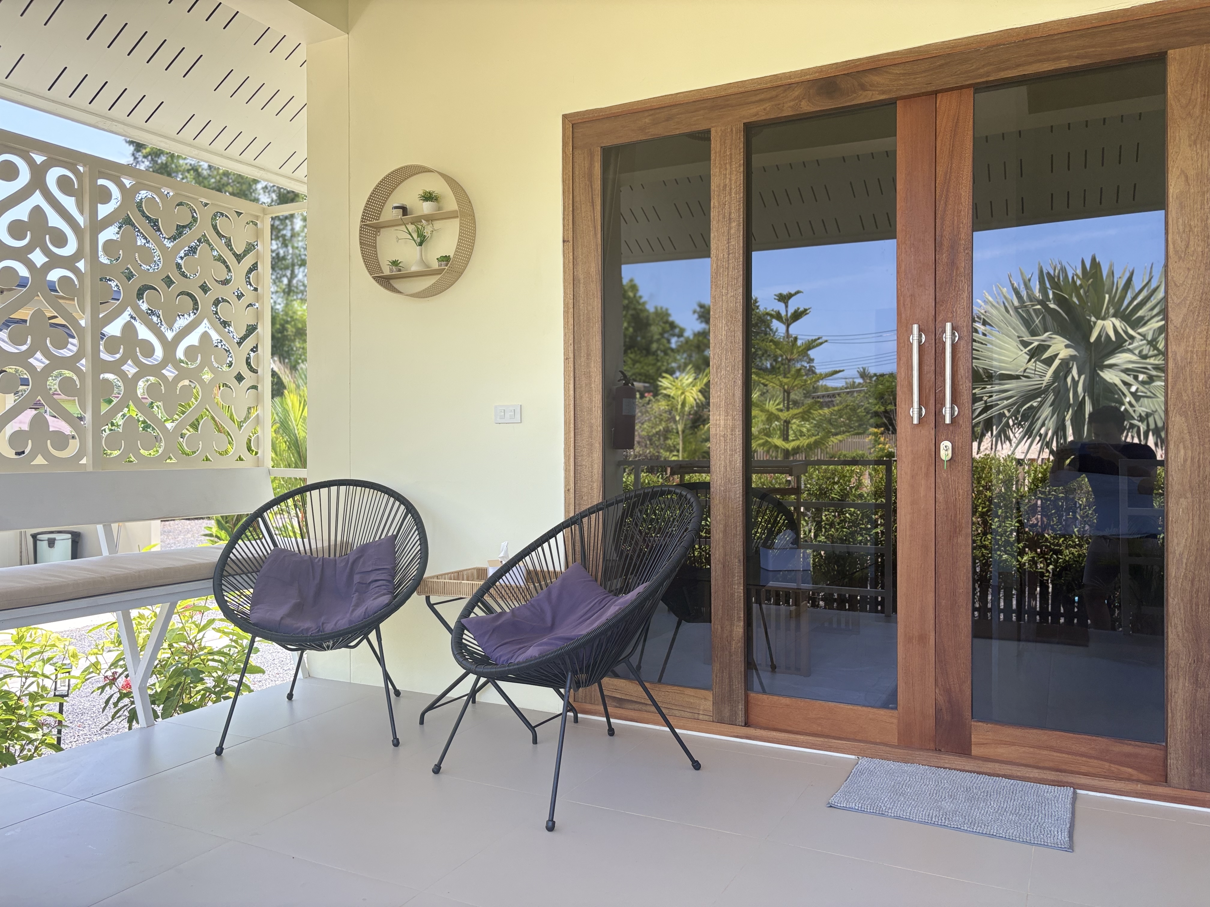 Peaceful covered porch with stylish seating and garden views