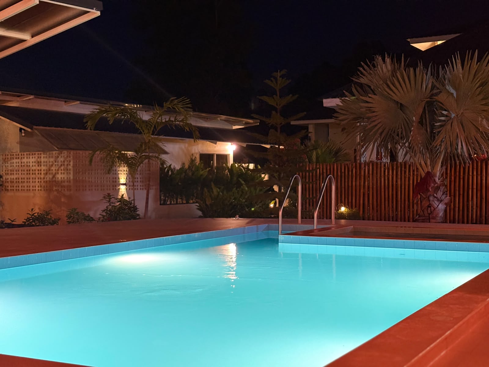 Private tropical pool glowing at night for a serene evening retreat