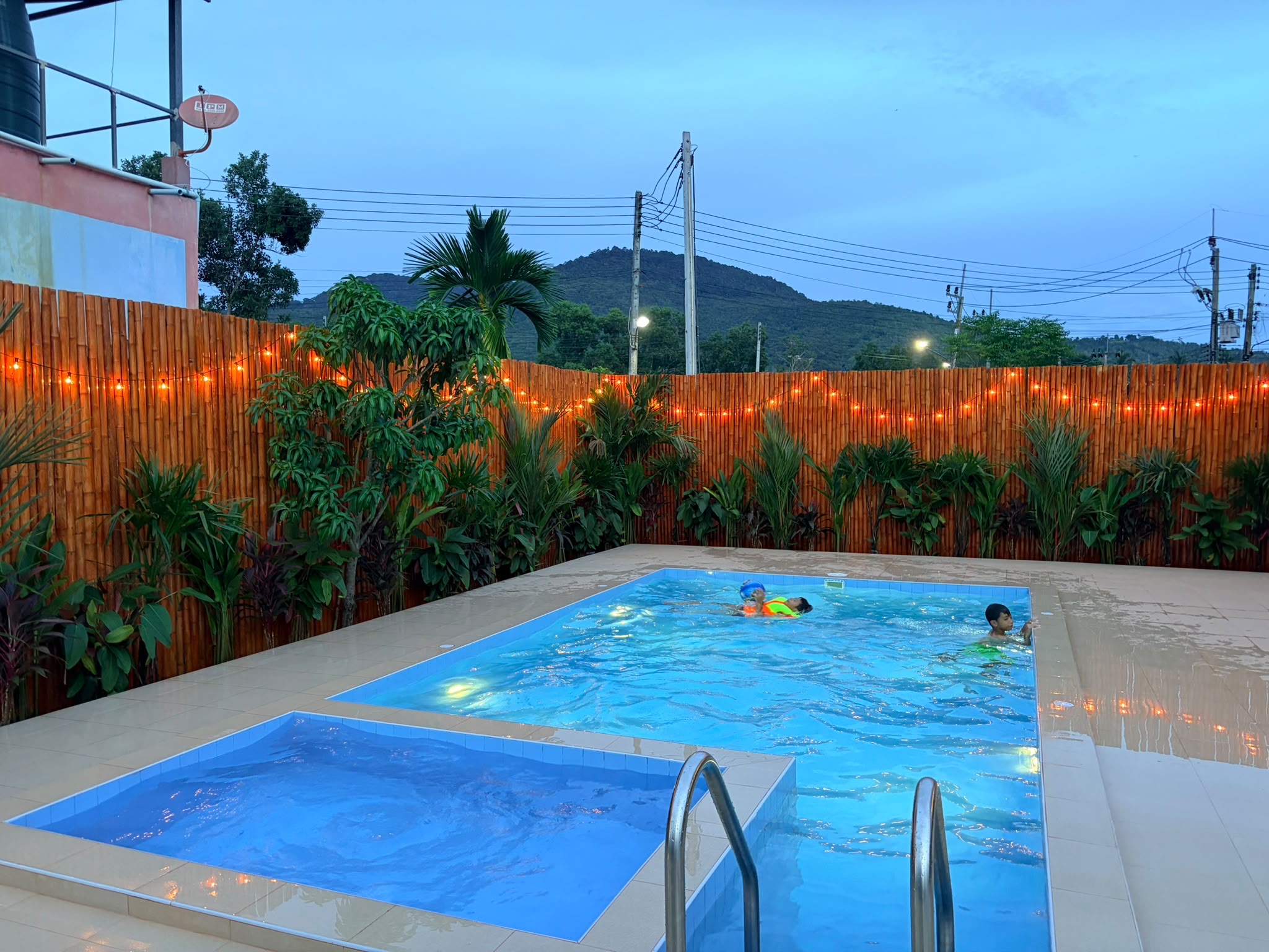 Private lit pool oasis with tropical vibes and scenic hillside views