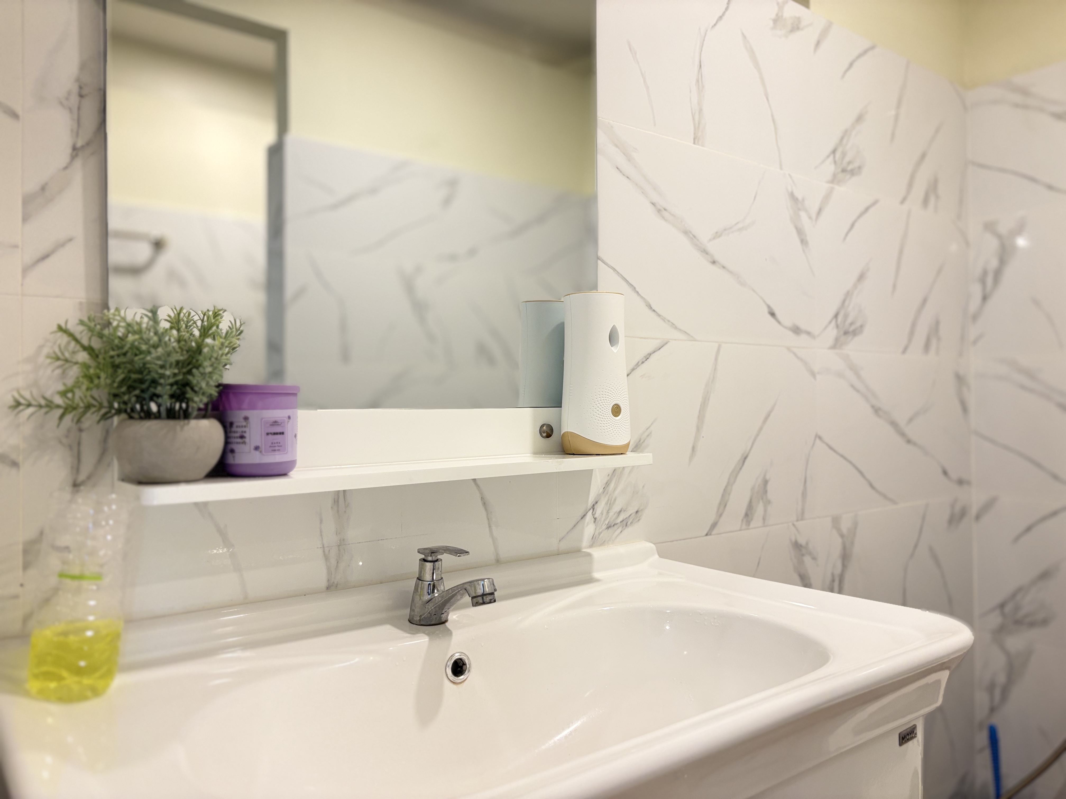 Bright modern bathroom with marble-look tile and clean vanity