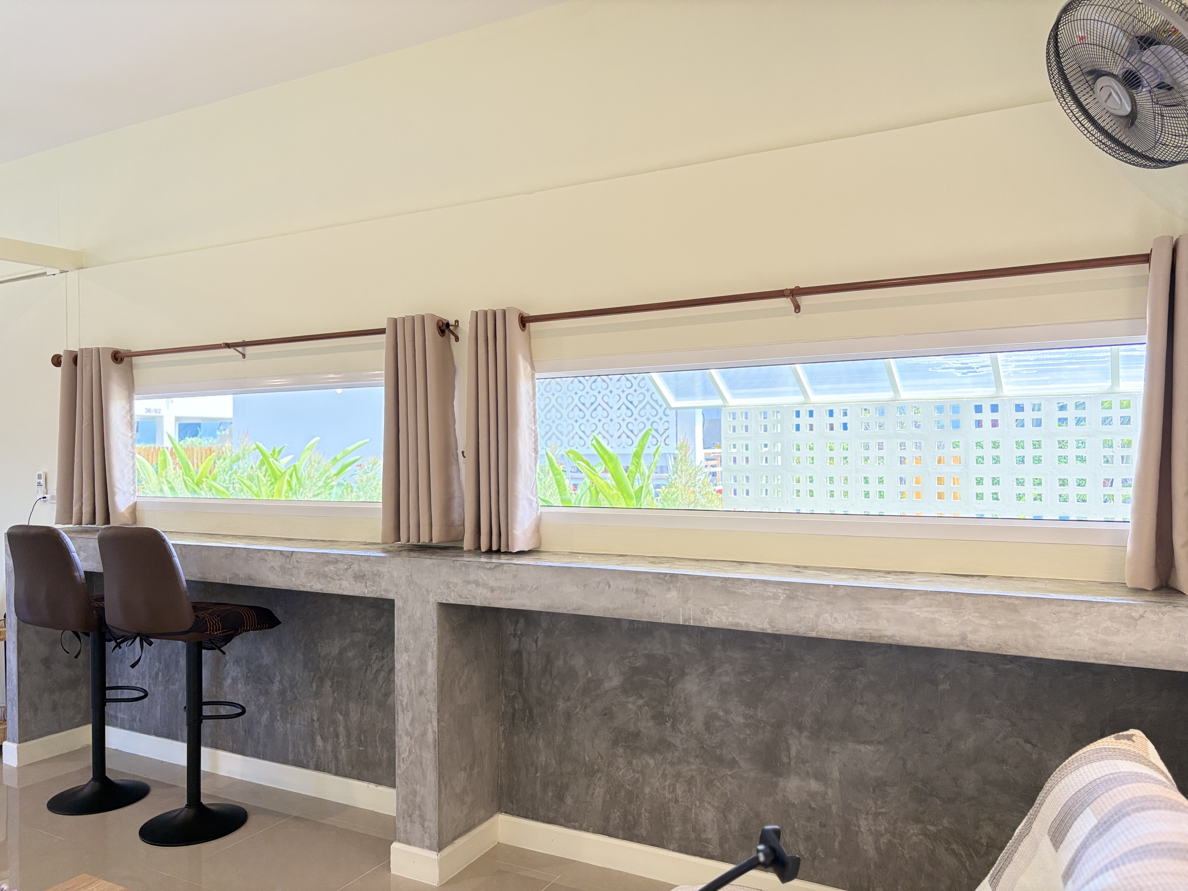 Bright window-side breakfast bar with stools and natural light