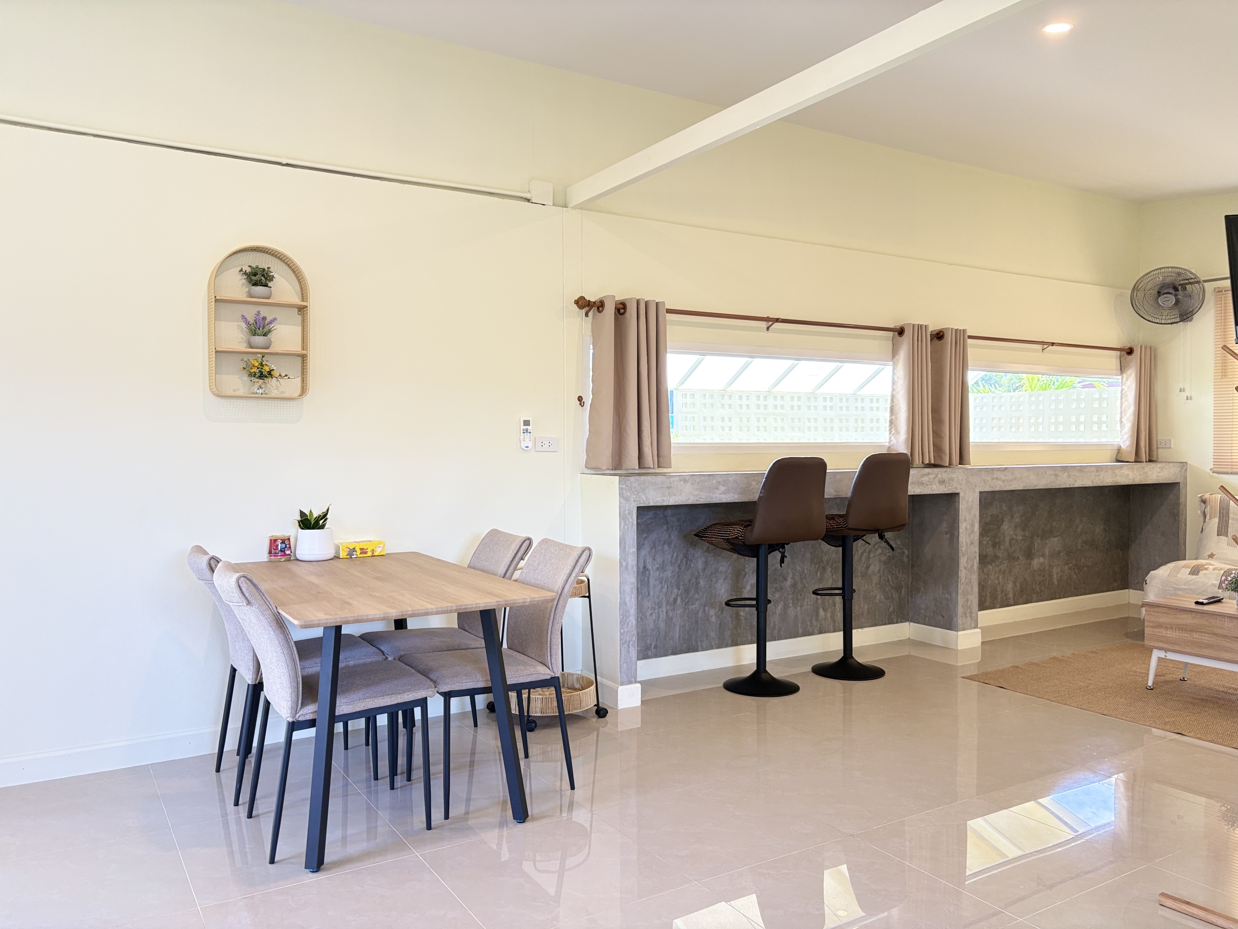 Bright dining area with breakfast bar, natural light, and modern seating