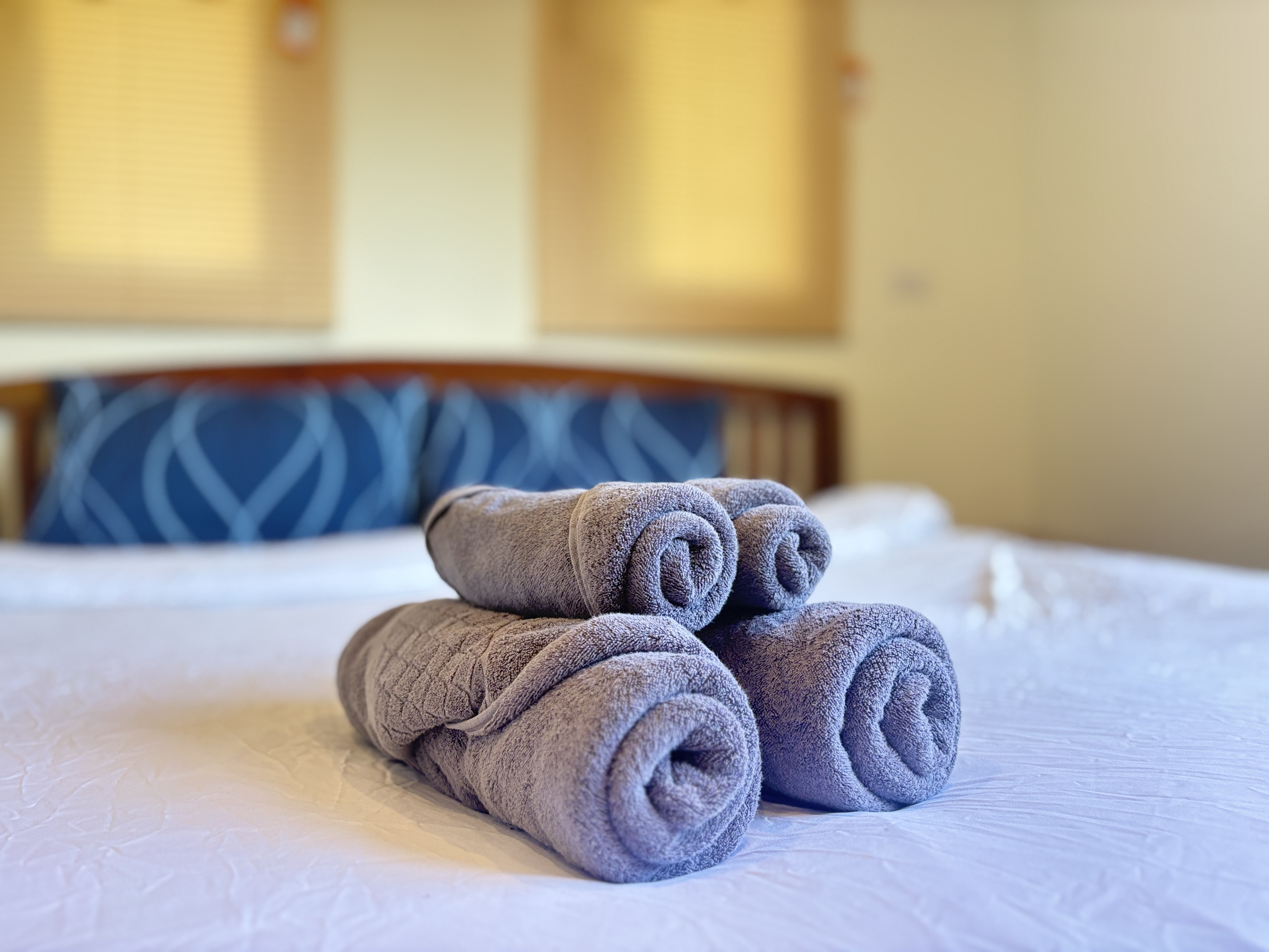 Fresh towels and a cozy bed welcome you to a warm, restful retreat