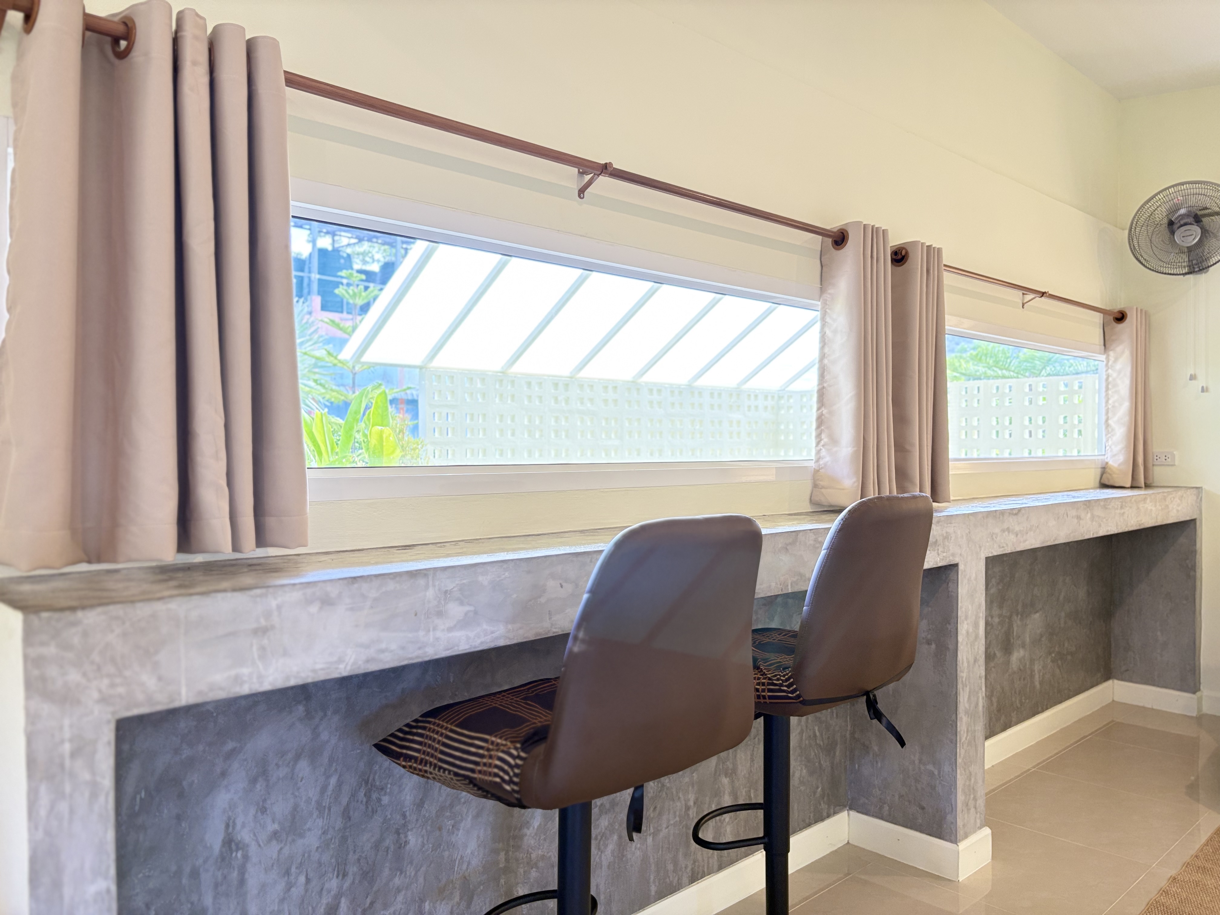 Bright window-side counter with stools—ideal for work or casual dining