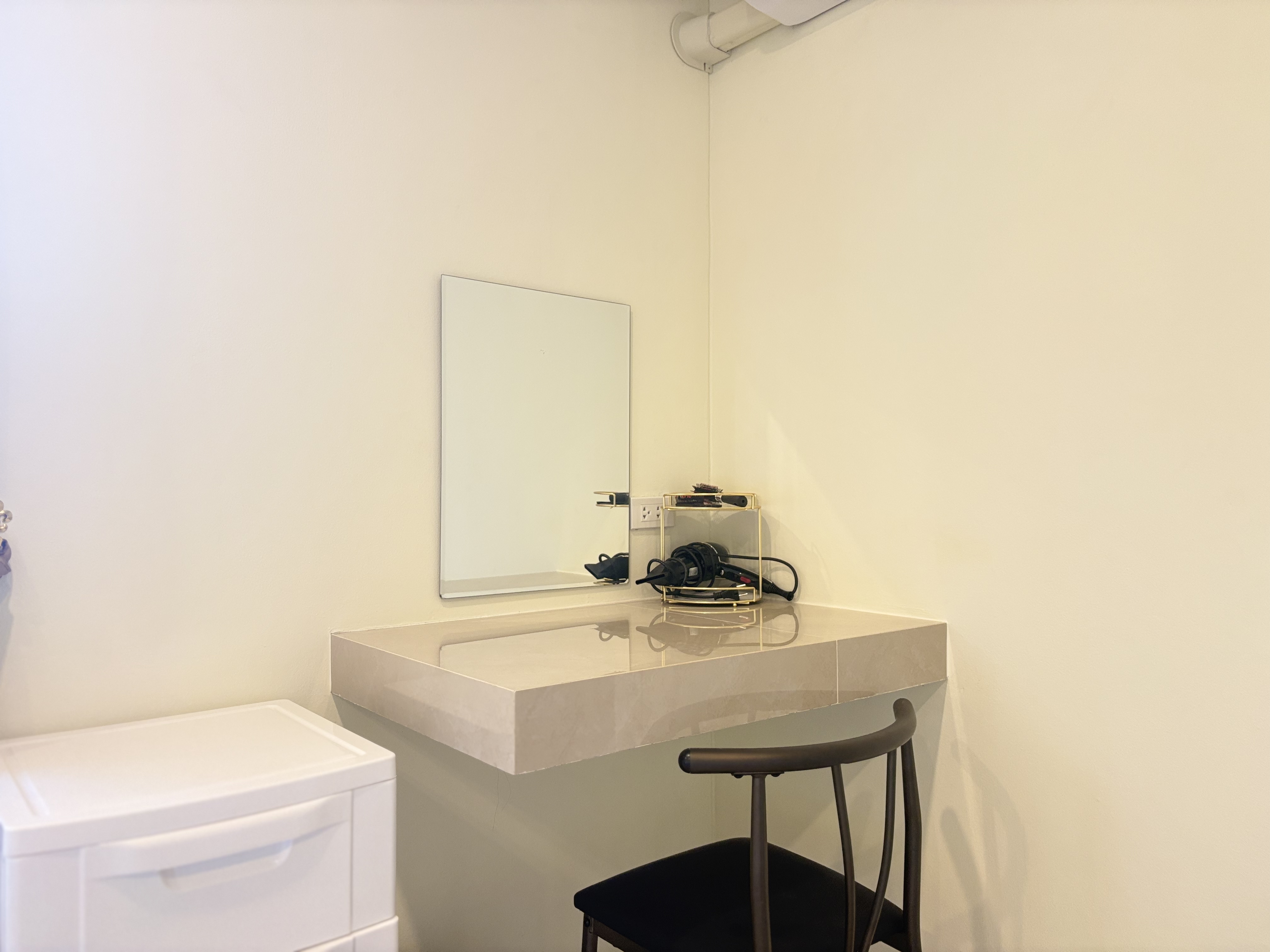 Minimalist vanity nook with mirror and chair for easy morning prep