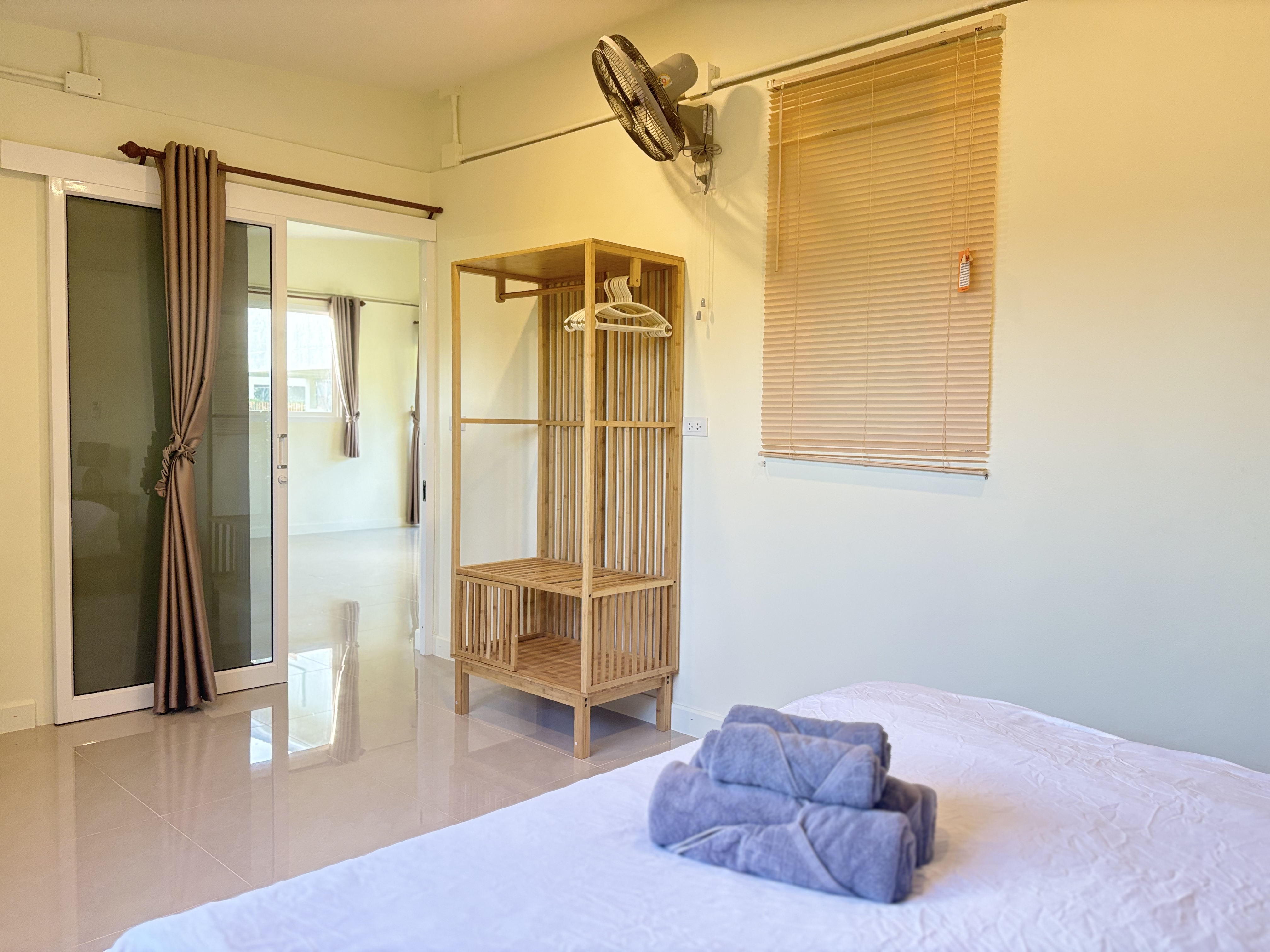 Bright minimalist bedroom with natural light and handy wooden storage