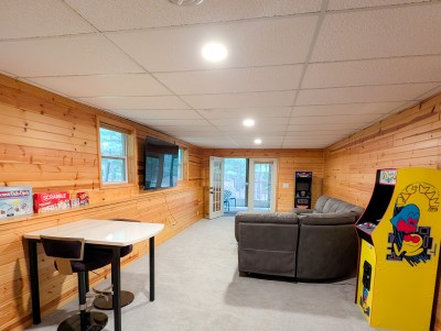 Game room with arcade games, big TV and patio access