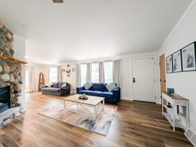 Main living room with stone fireplace and lots of natural light