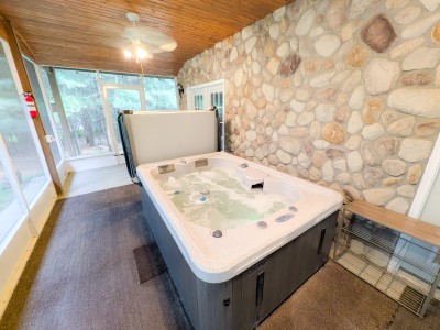 Hot tub on the covered, screened lower porch