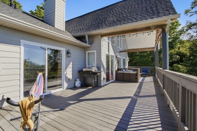 Spacious private deck with grill, covered lounge, and serene treetop views