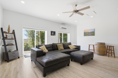 Bright modern living room with large sectional and easy outdoor access