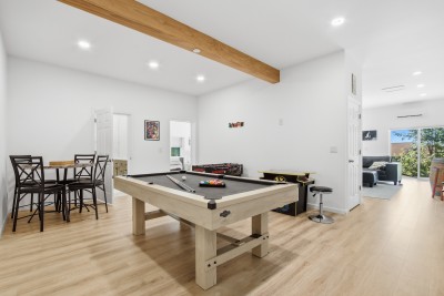 Bright game room with pool table, arcade fun, and open-concept layout
