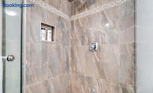 Modern tiled walk-in shower with glass door and built-in niche