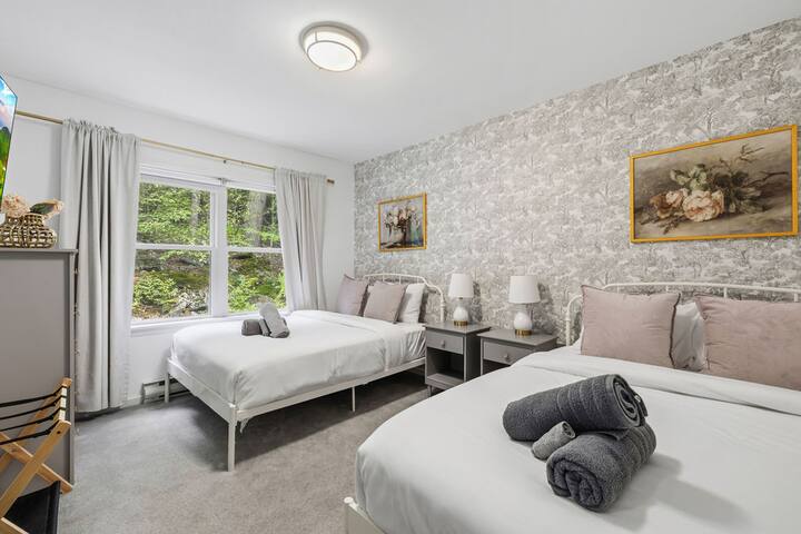 Bright twin bedroom with garden views and elegant, cozy décor