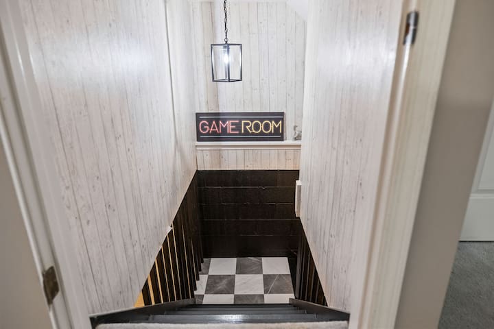Follow the stairs to a fun-filled game room with stylish retro flair