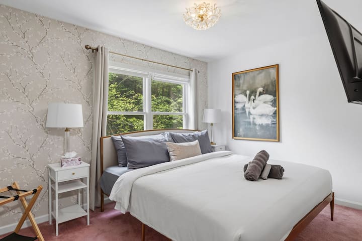 Bright, elegant bedroom with garden views and a cozy, refined feel