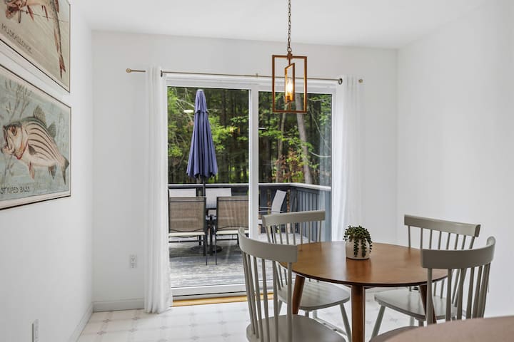 Bright dining nook with deck access and serene wooded views