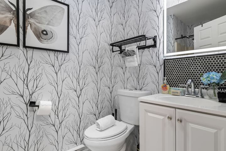 Stylish modern bathroom with designer wallpaper and fresh, boutique touches