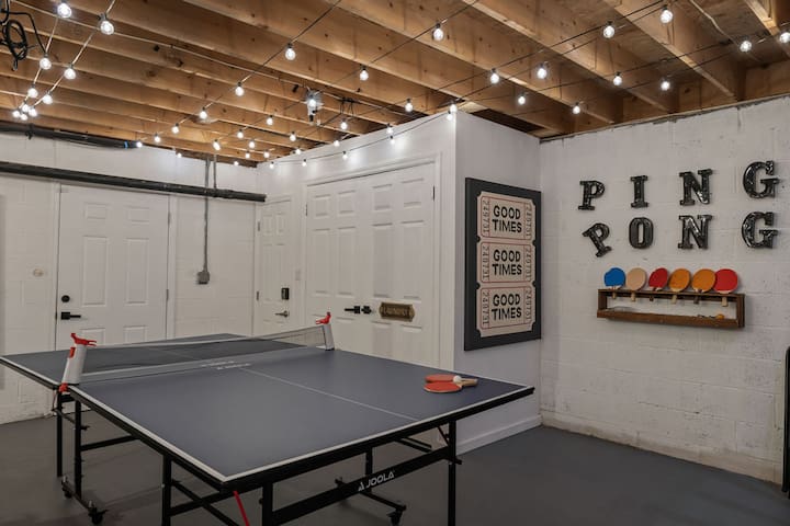 Cozy game room with ping pong table and café lights for indoor fun