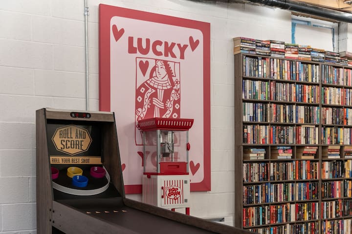 Game room fun with arcade play, popcorn, and a library wall