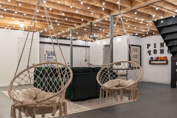 Fun game lounge with swing chairs, cozy seating, and twinkle lights