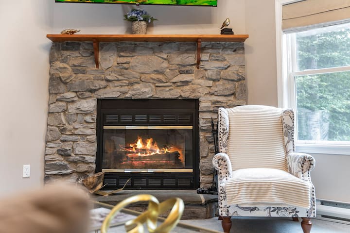 Cozy stone fireplace nook with warm seating and natural light
