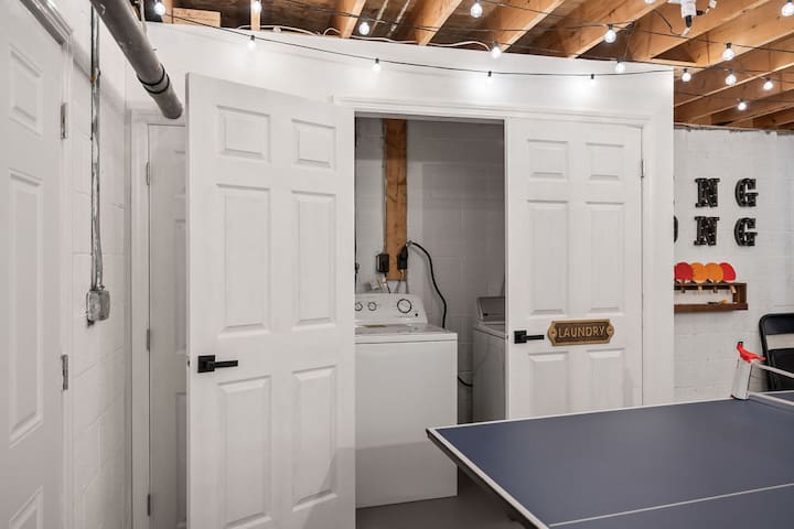 Game room with ping pong and hidden in-unit laundry convenience
