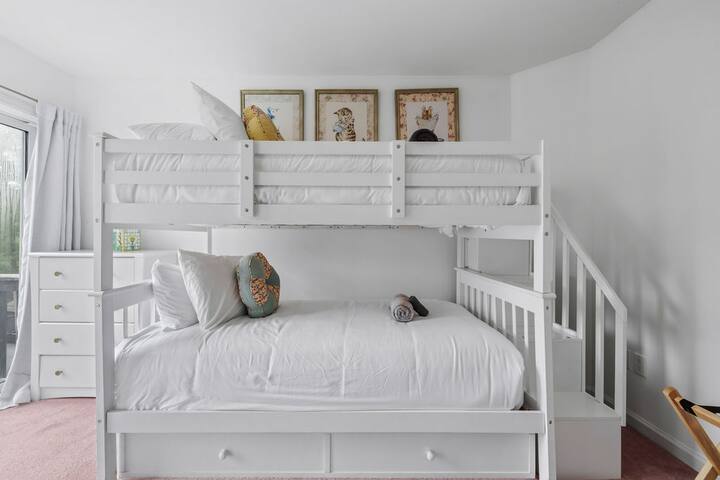 Bright family-friendly bunk room with built-in storage and crisp bedding
