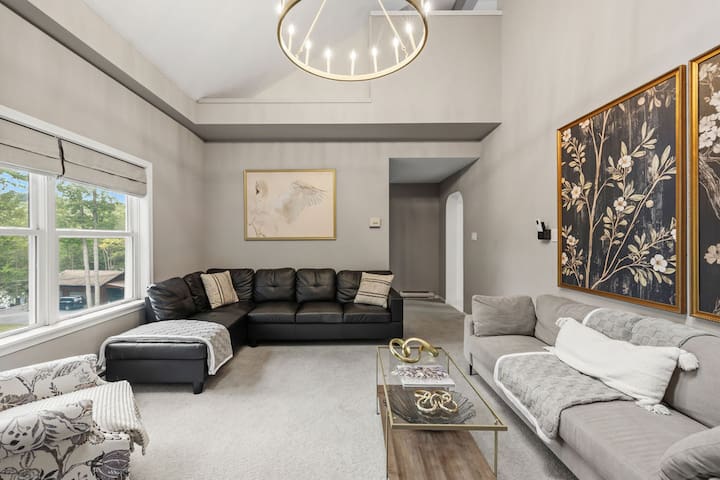 Bright vaulted living room with plush seating and elegant modern style