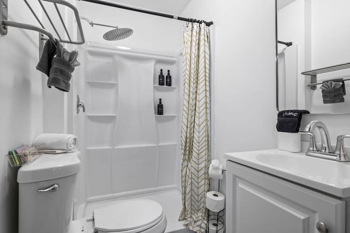 Bright modern bathroom with rainfall shower and clean guest-ready style