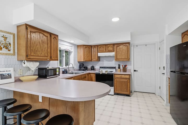 Bright full kitchen with bar seating and plenty of counter space