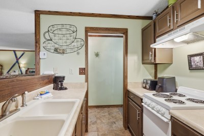 Cozy full kitchen with ample counter space and charming rustic details