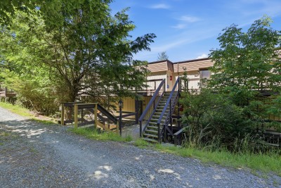 Wooded mountain-style exterior with private entry and peaceful surroundings