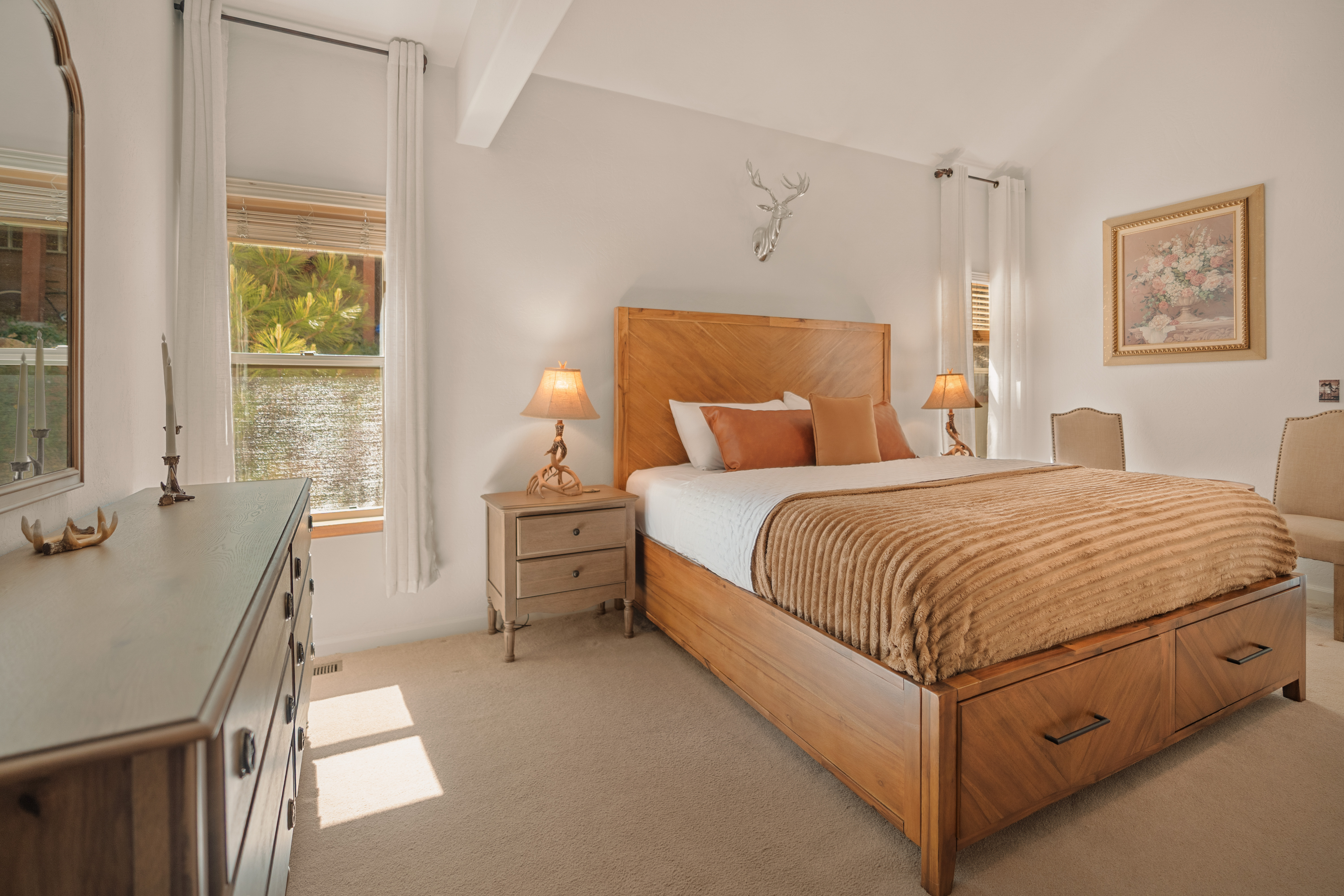Bright, elegant bedroom with natural light and cozy wood accents