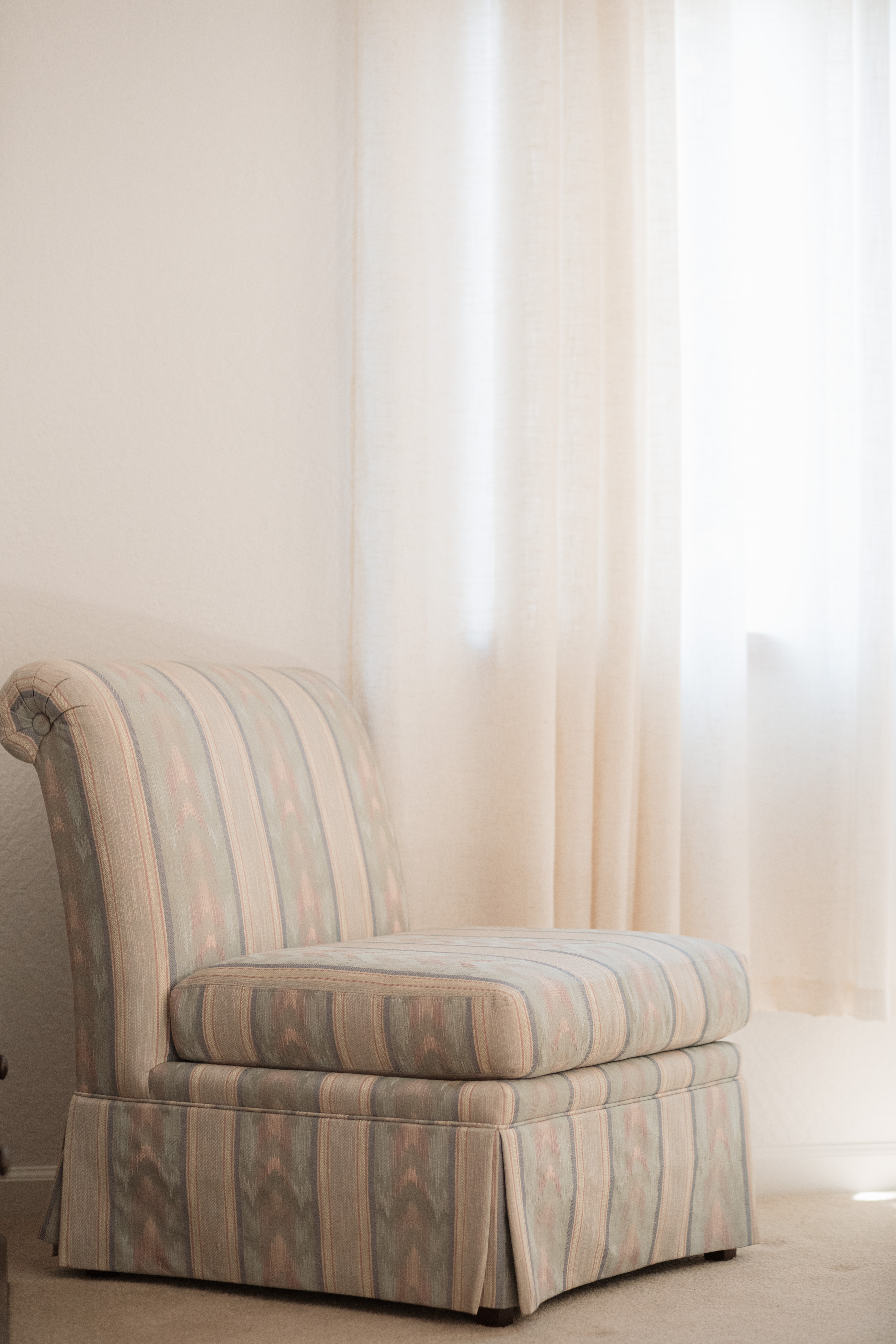 Cozy accent chair in a bright, softly lit corner