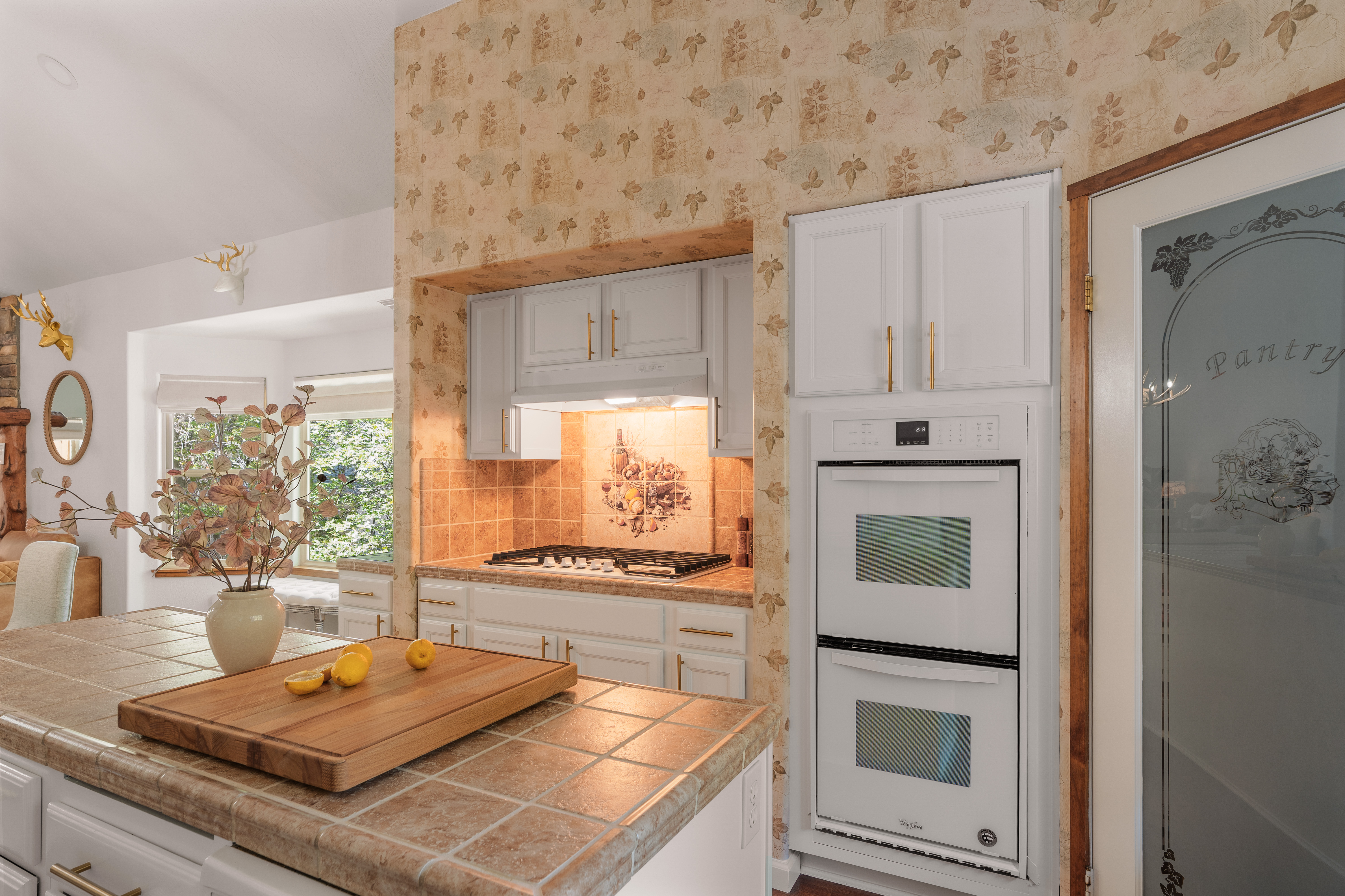 Charming vintage-style kitchen with double ovens and sunny prep island