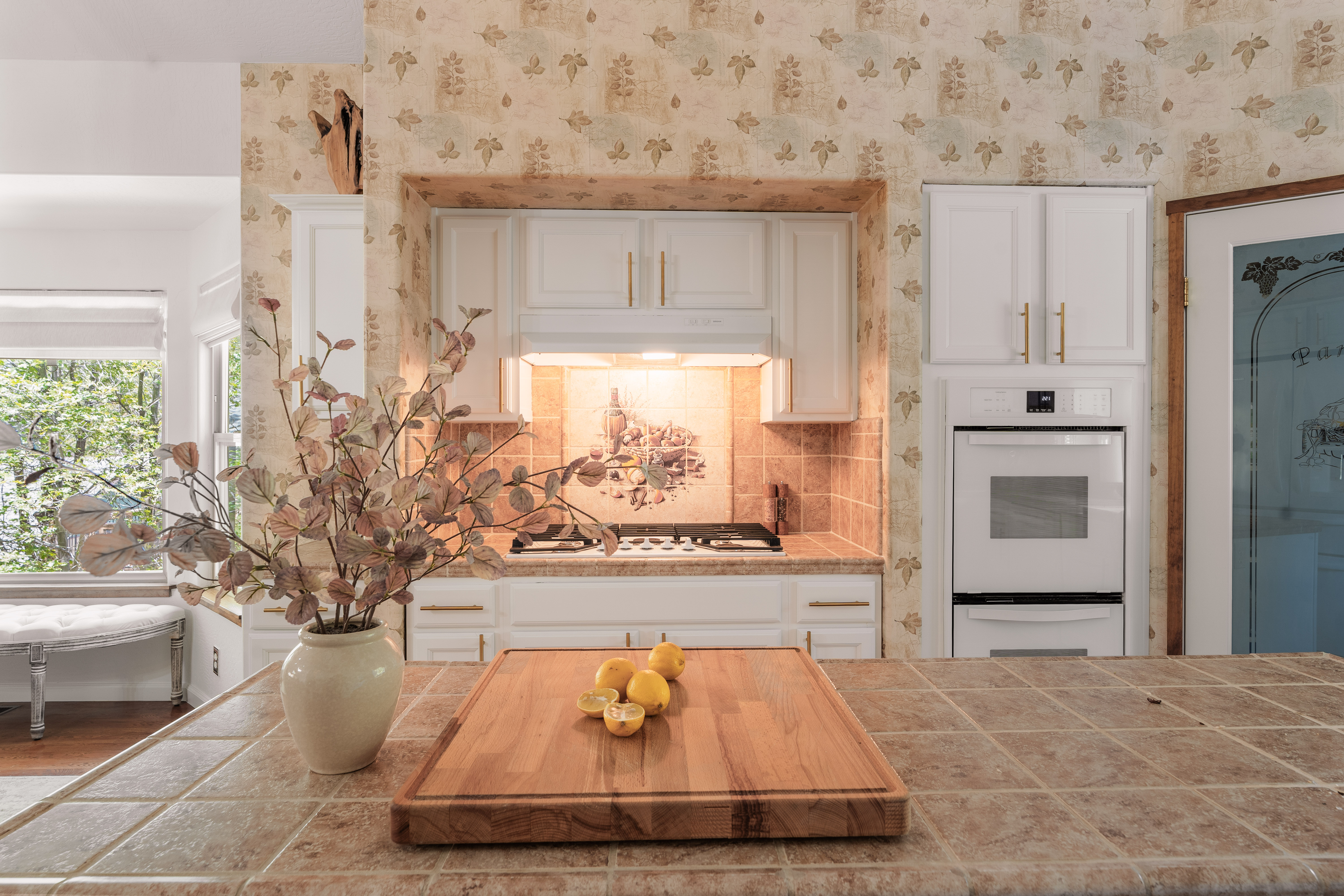 Charming vintage kitchen with floral wallpaper and warm natural touches